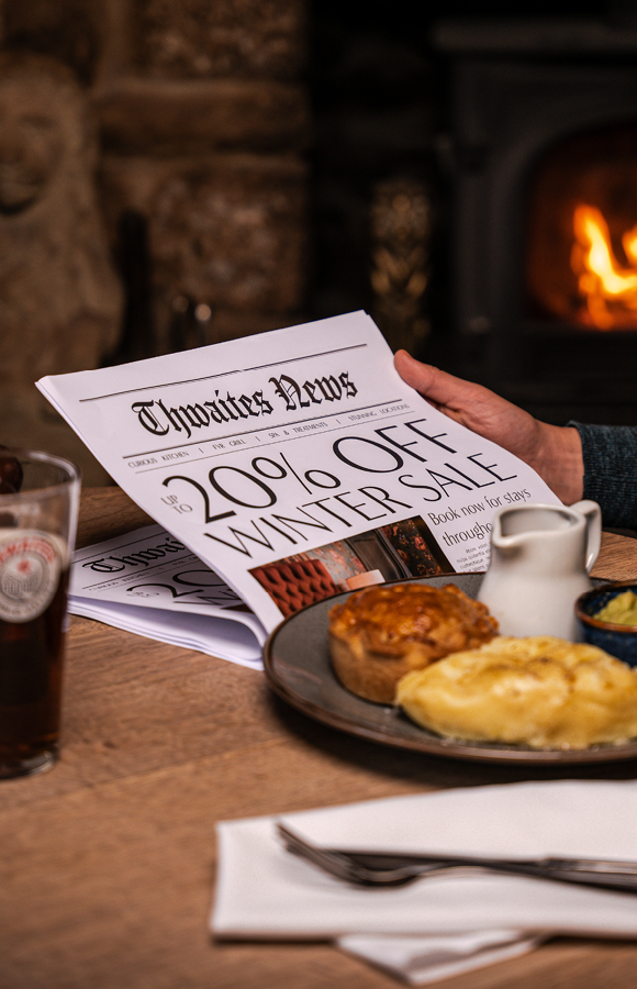'up to 20% off' newspaper at a pub table