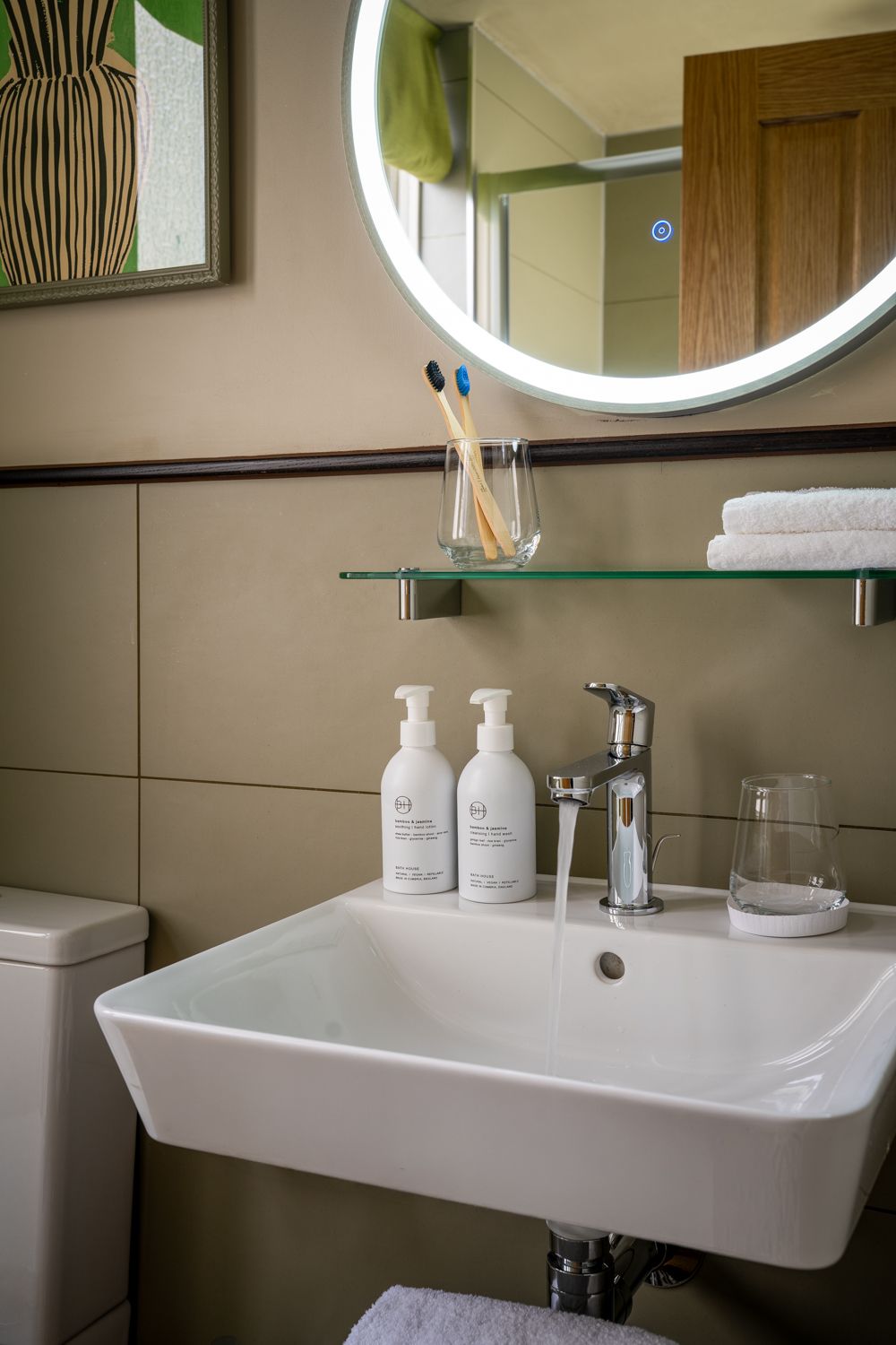 bathroom sink with bath house toiletries in the family bedroom