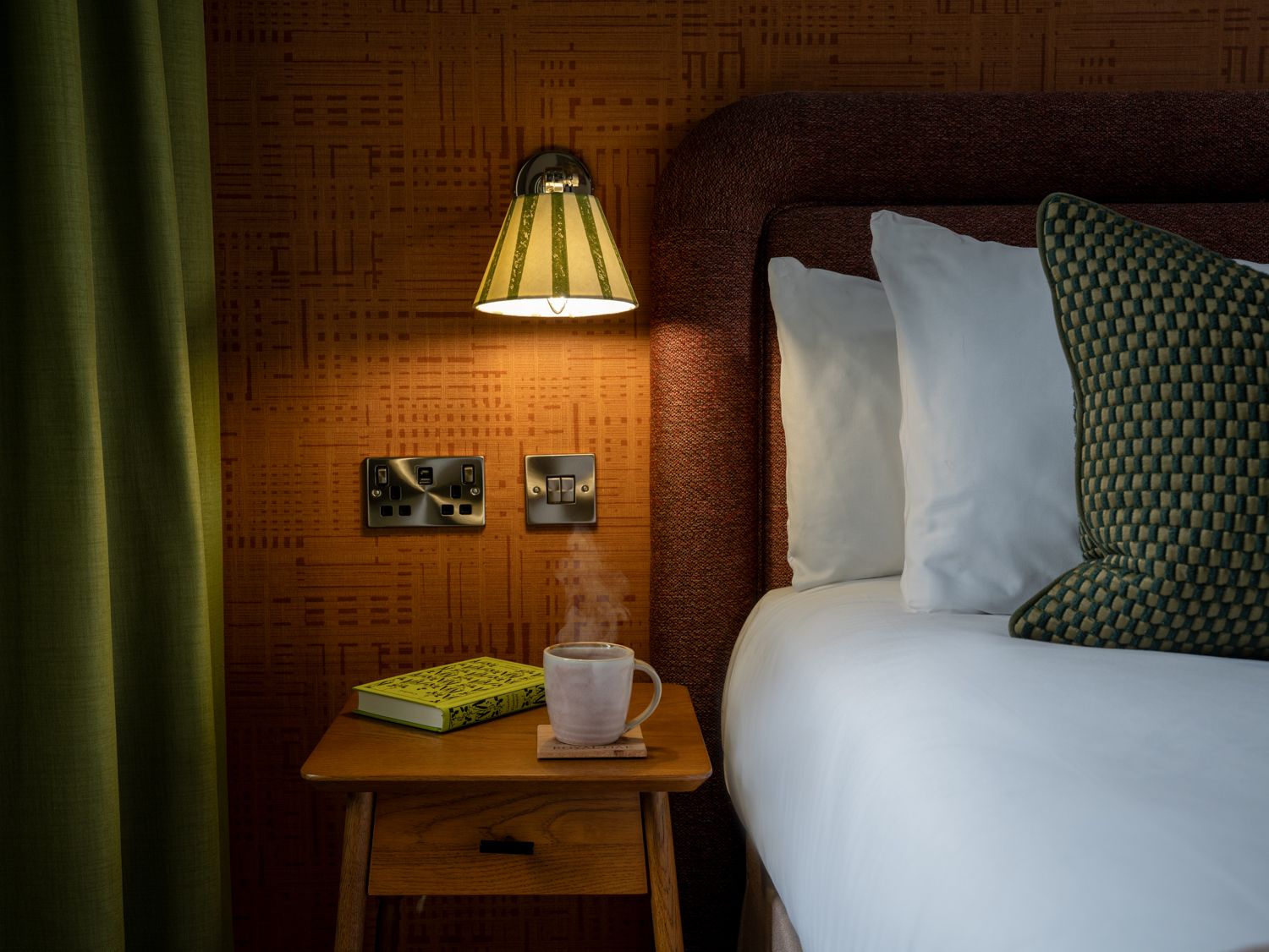 bedside table with a cup of coffee