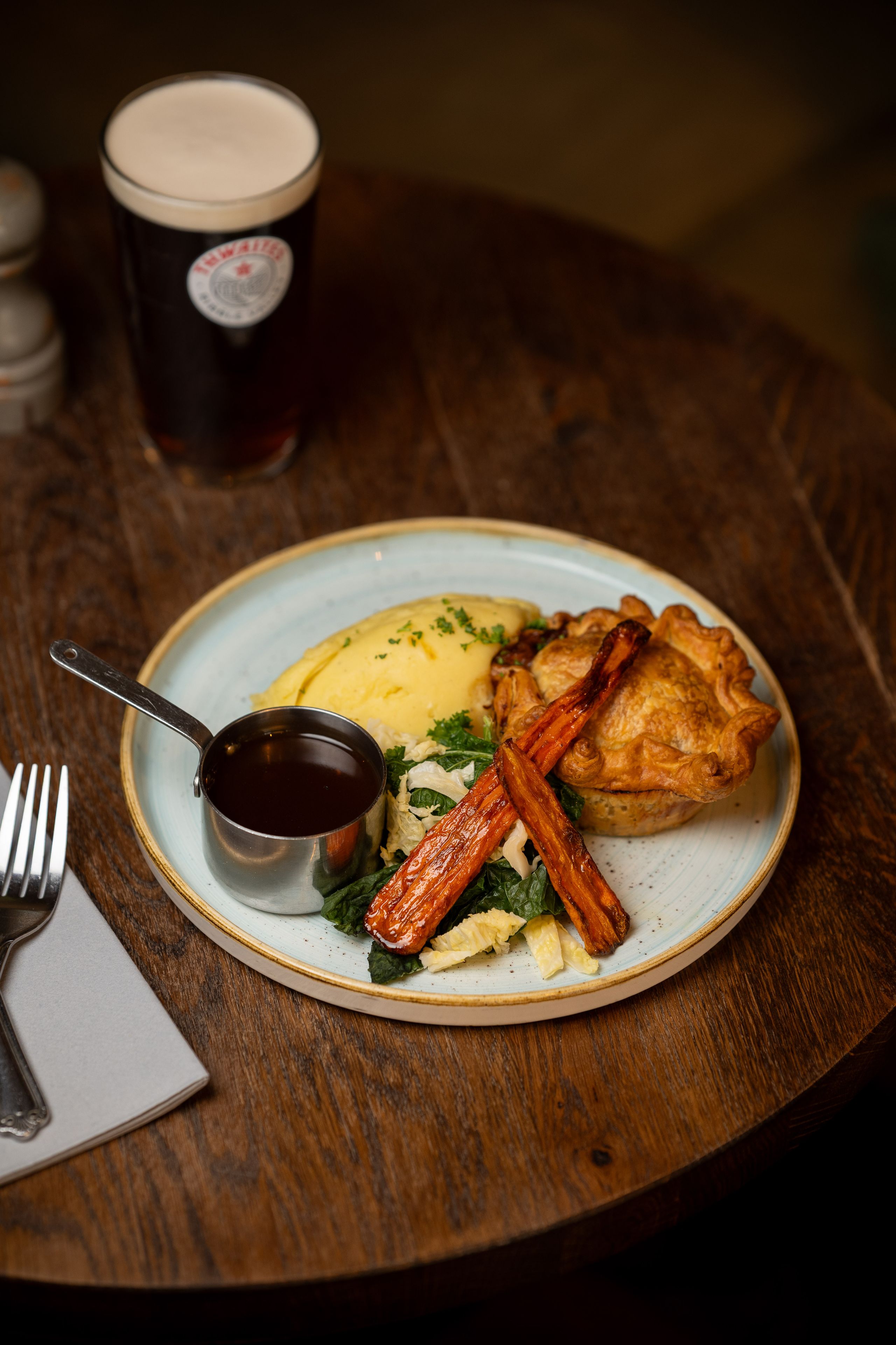 pie and mash dish with a pint of thwaites ale